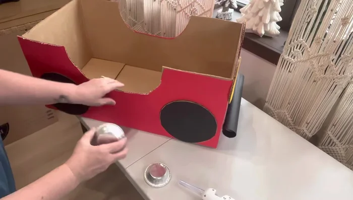 Add hubcaps: Hot glue pie tins to the tires for hubcaps.