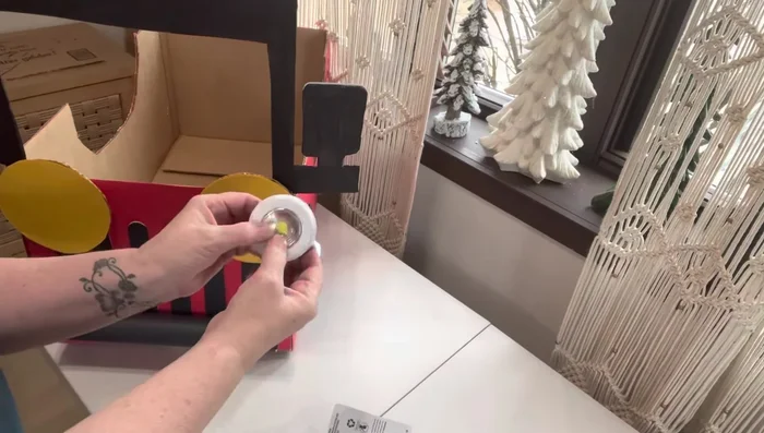 Attach push lights (optional): Hot glue push lights to the front of the car.