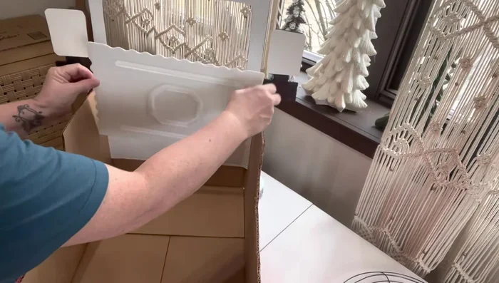 Add a front cover piece (optional): Hot glue a styrofoam-like piece to cover up extra cardboard.