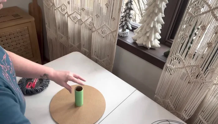 Create and attach the steering wheel: Cut a hole in a circular cardboard piece and insert a toilet paper roll. Add a steering wheel cover.