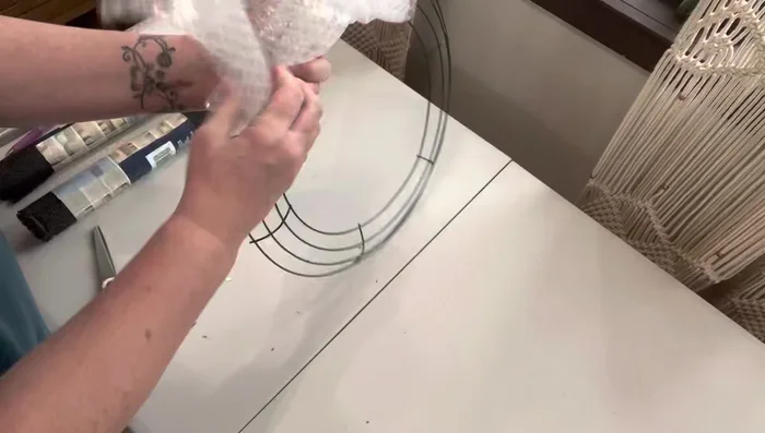 Attach the spare tire: Add popsicle sticks to the spare tire for detail, and then attach to the back of the car.