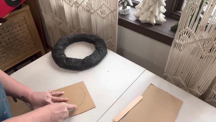 Attach the spare tire: Add popsicle sticks to the spare tire for detail, and then attach to the back of the car.