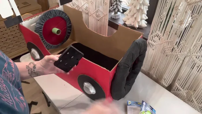 Add finishing touches (optional): Attach decorative elements such as door handles, keys, a light switch, and a doormat.