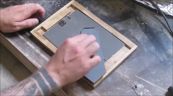 Attach the backing and glass.