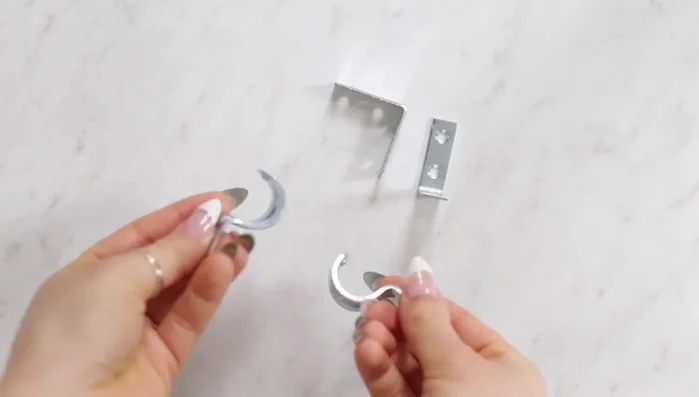 Create wall brackets using 1.5-inch corner braces, 0.5-inch one-hole straps, and 0.5-inch machine screws with nuts.