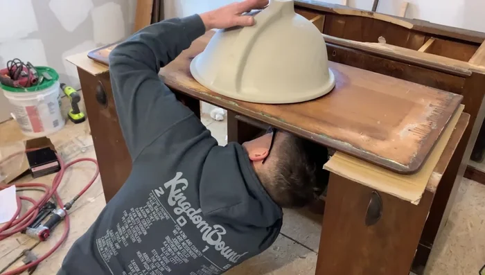 Apply silicone, set the sink in place, and secure it using sink hardware.