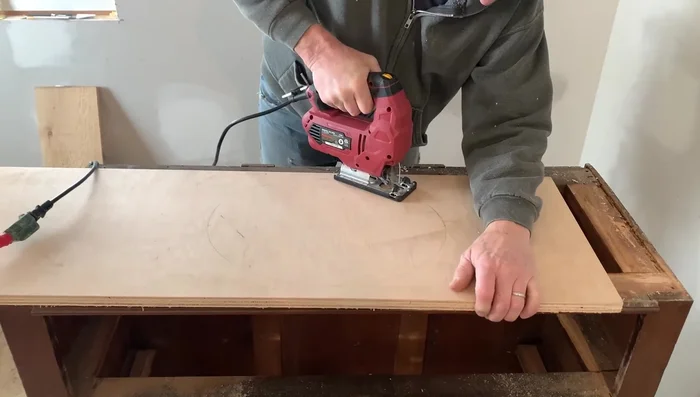 Cut out the sink hole using a drill, jigsaw, and router for a smooth edge. Adjust the cutout as needed to ensure a proper fit.