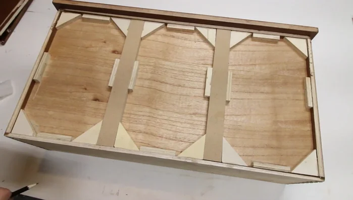 Assemble and secure the cutout section of the drawer with wood glue and brad nails.