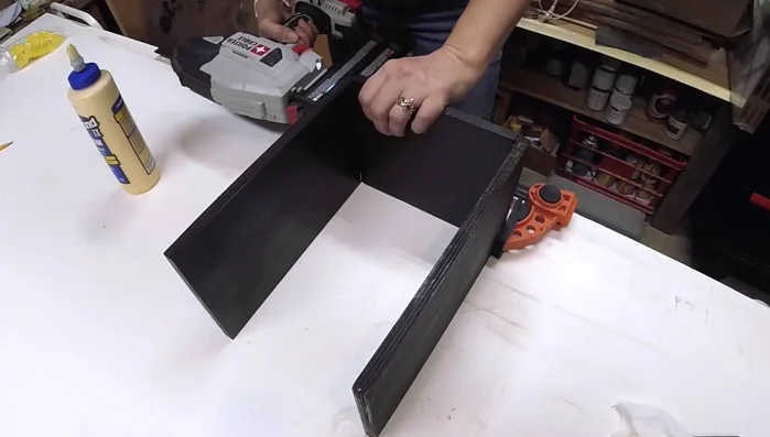 Assemble and secure the cutout section of the drawer with wood glue and brad nails.