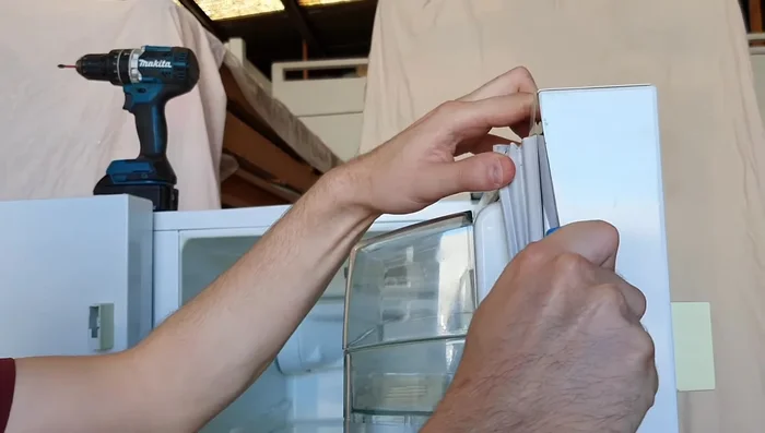 Once the adhesive is loosened, carefully remove the old seal.