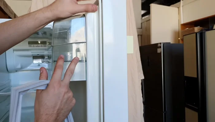 Tuck the lip of the new seal securely behind the door liner all the way around.