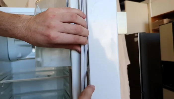 Tuck the lip of the new seal securely behind the door liner all the way around.