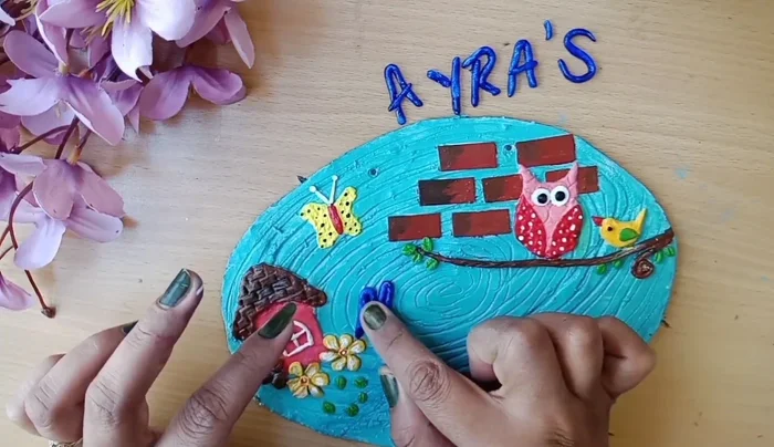 Stick the name onto the board with glue.