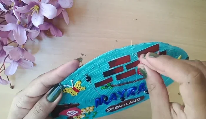 Attach a neckpiece for hanging.