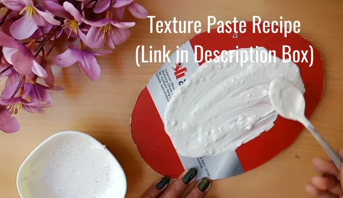 Roll out clay and spread it on the board. Use a tool for texture.