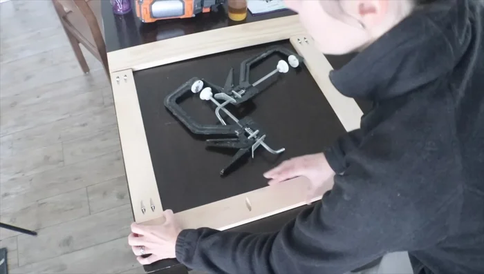 Install the face frame, pre-drilling holes to attach the hinges to the doors.