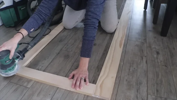 Sand the face frame and doors to create a smooth surface for painting or finishing.