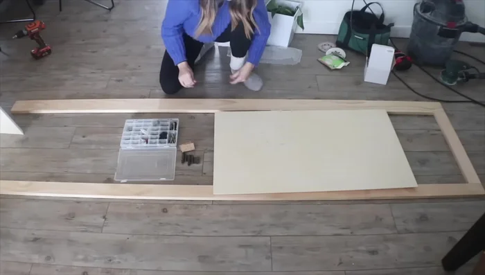 Install the face frame, pre-drilling holes to attach the hinges to the doors.