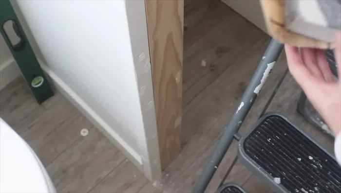 Caulk all seams and touch up paint. Add baseboards and additional hooks or baskets as desired.