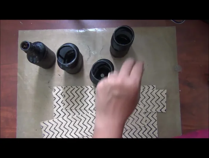 Apply a strong adhesive (silicon glue recommended) to the bottle and adhere the burlap strip, ensuring it's smooth and wrinkle-free.