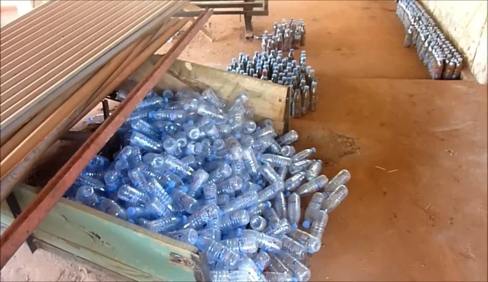 Fill the bottles with dirt or rubbish to strengthen them.