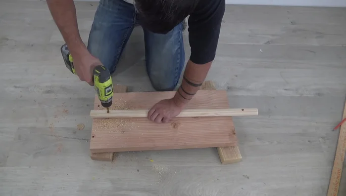 Prepare and attach hanging hardware (e.g., dowel, rope, and wall brackets).