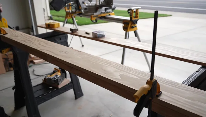 Attach corner brackets to the tops of posts; drill pilot holes for bolts.