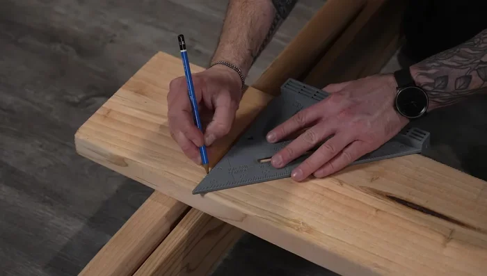 Attach corner brackets to the tops of posts; drill pilot holes for bolts.