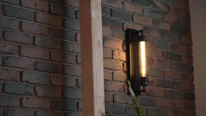 Attach corner brackets to the tops of posts; drill pilot holes for bolts.