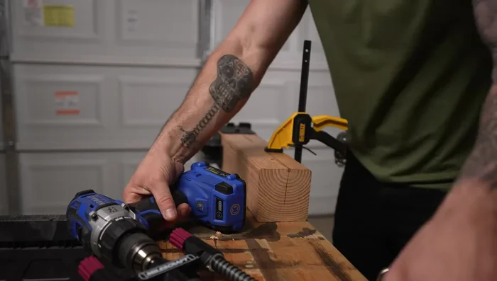 Attach corner brackets to the tops of posts; drill pilot holes for bolts.