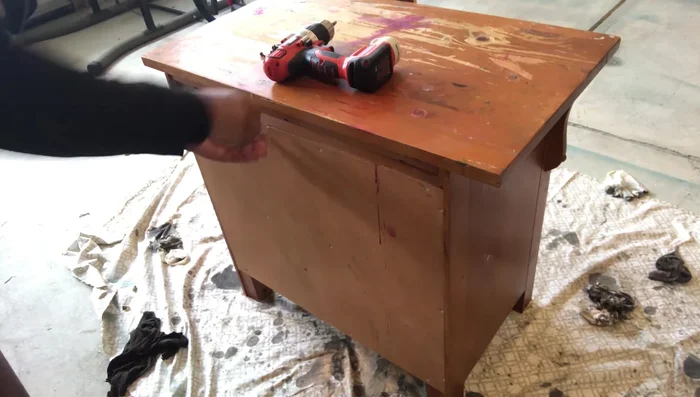 Remove the top of the dresser.