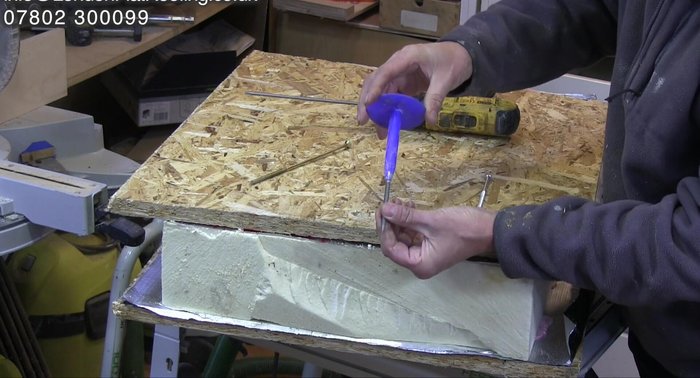 Inspecting the firmly broken fixings for proper installation.