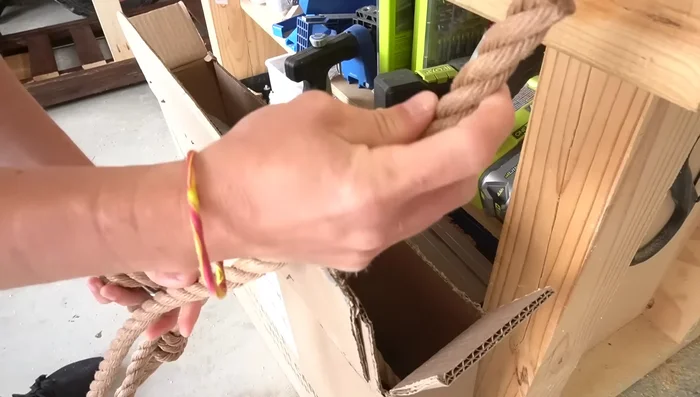 Drill holes through the bottom 2x4s to attach the ropes. Use a 3/4 inch Forstner bit for clean holes.