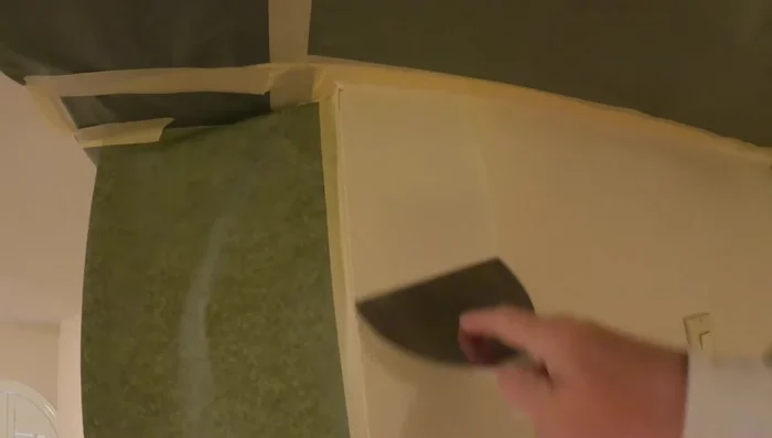 Knock down texture: Using a 6-inch knife, gently rake the hardened plaster to create a knockdown texture. This helps to level the surface and remove excess material (283.84).