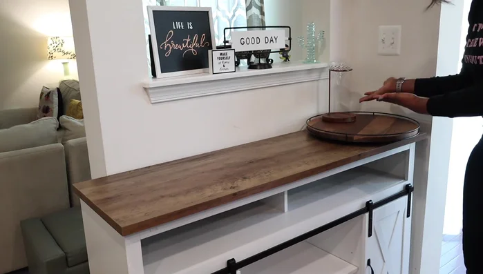 Add decorative items to the lazy susan (faux plant, cream pourer).