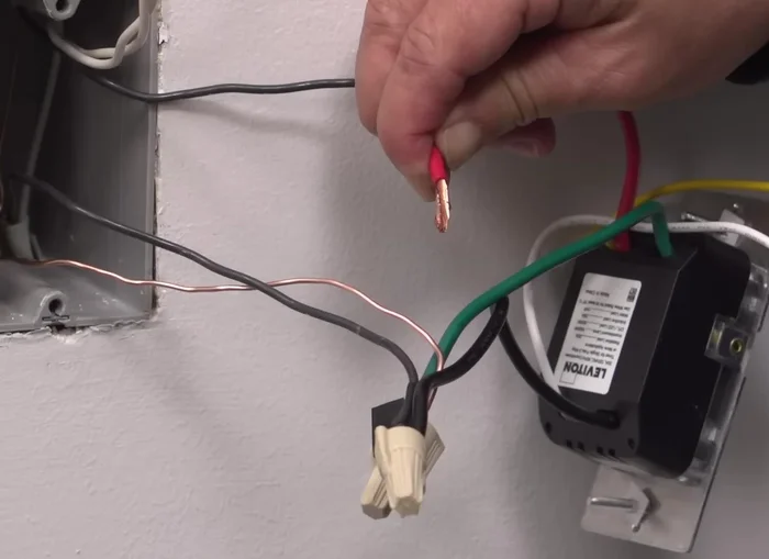 Prepare the wires for installation by removing a small piece of insulation from the pigtail leads on the timer switch and twisting the exposed stranded copper wiring clockwise.