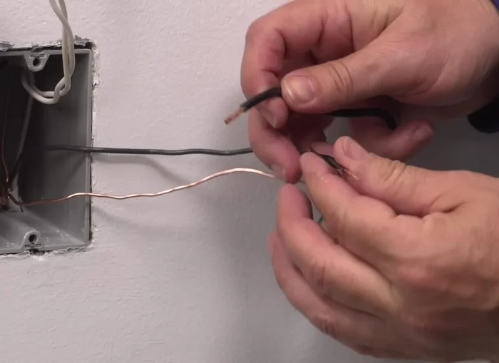 Connect the neutral wallbox wire to the white lead using a wire connector.