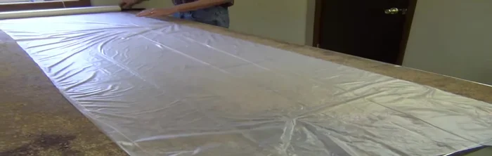 Allow the foam to expand slightly, ensuring the cover is properly aligned before fully removing the vacuum and silk film.