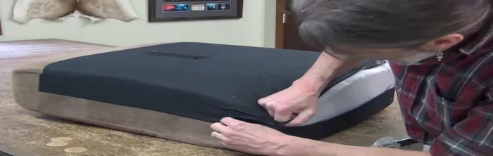 Zip up the cushion carefully, avoiding damage to the zipper.