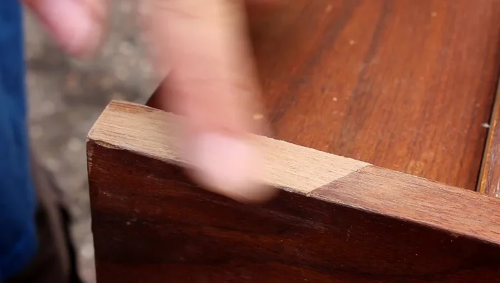 Apply stain and finish to match the existing wood (process not shown in video).