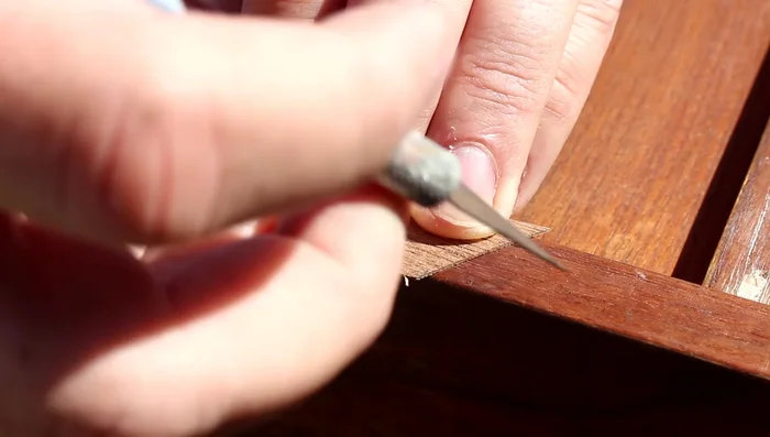 Press the veneer patch firmly into place and let it dry completely.