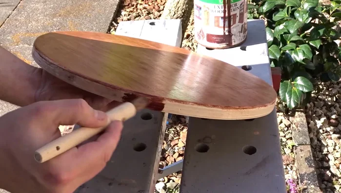 Apply three coats of mahogany-colored exterior wood stain to the new seats for protection.