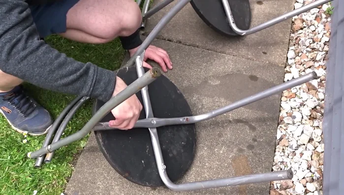 Lightly sand the metal chair frames to prepare for painting. Remove dust with a cloth.