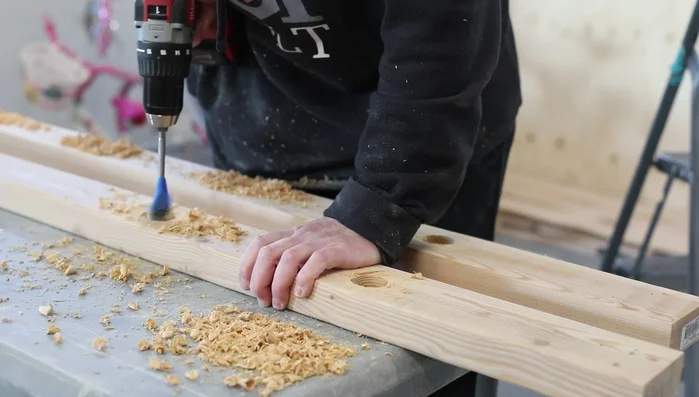 Install ladder: Build and attach the ladder using 2x4s and dowels.