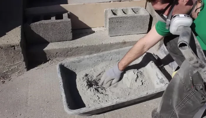 Use a steel trowel to smooth the edges between the new and old cement, checking for levelness with a 24-inch level. Fill low spots and scrape off high spots.
