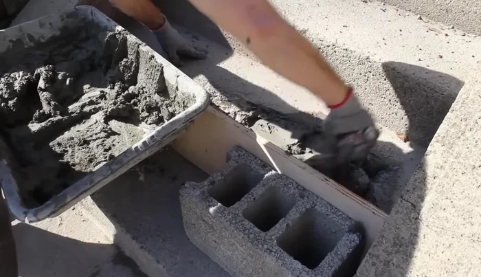 Use a steel trowel to smooth the edges between the new and old cement, checking for levelness with a 24-inch level. Fill low spots and scrape off high spots.