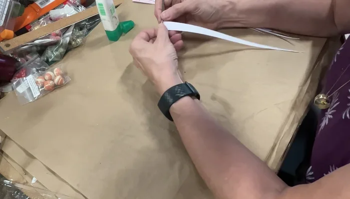 Wind the beads: Starting from the wide end, tightly wind each strip around a piece of wire or dowel, keeping the bead centered. Glue the tip to secure the winding.