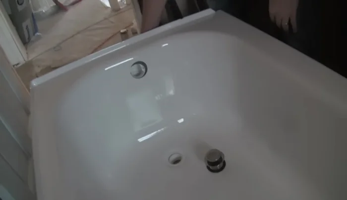 Position the bottom drain and attach it to the tub using plumber's putty.