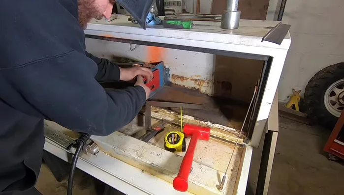 Weld the drawer fronts to the slide plates.