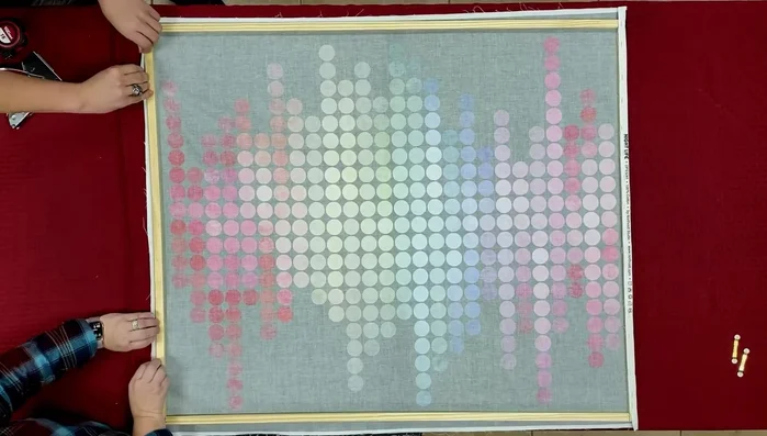 Staple the top and bottom edges of the fabric to the frame, stretching the fabric evenly. Tuck the corners to create a neat finish and staple them securely.